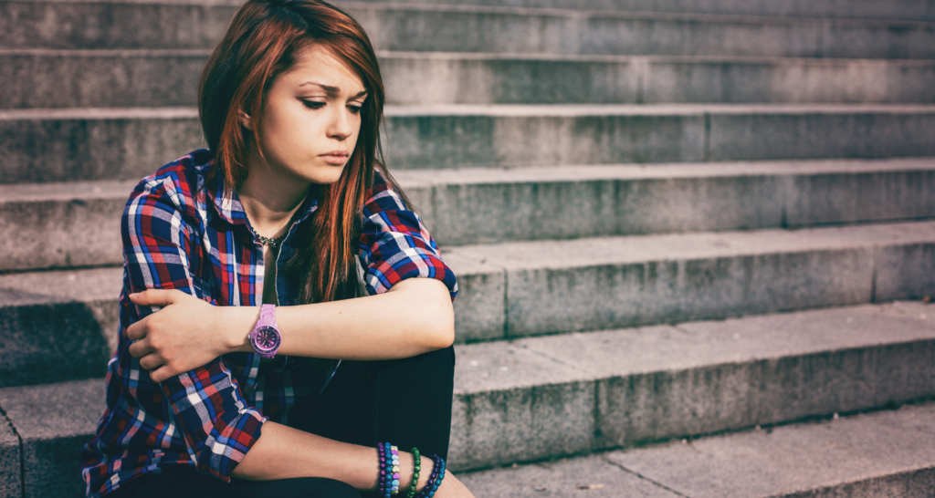 Young girl looking unsure sitting on steps